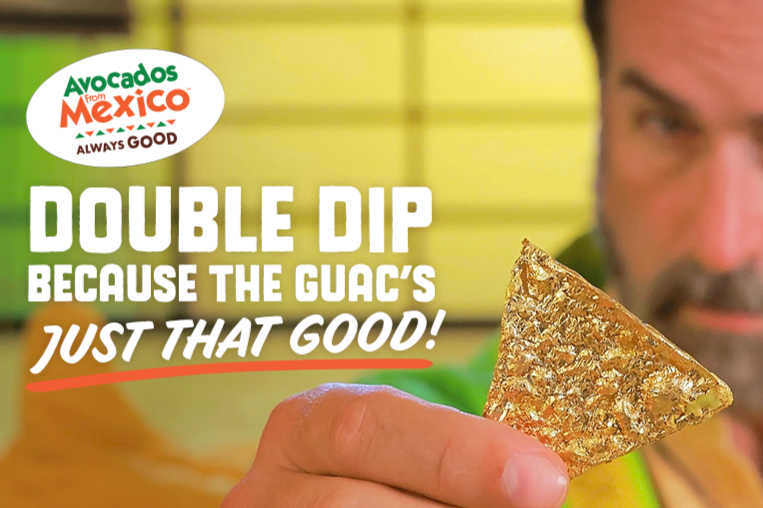 Close-up promo image for the Avocados From Mexico Double Dip Sweepstakes showing a man holding a tortilla chip covered in gold, highlighting the Golden Double-Dip Chip prize and the Avocados From Mexico Golden Double-Dip Chip Sweepstakes giveaway.