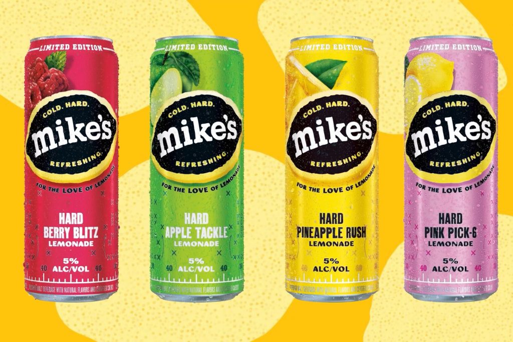 Four limited edition Mike’s Hard Lemonade cans in bright flavors—Hard Berry Blitz, Hard Apple Tackle, Hard Pineapple Rush, and Hard Pink Pick-6—shown as the prize image for the Mike’s Hard Lemonade Fantasy Life Sweepstakes, a football-season giveaway featuring a championship game trip and weekly prizes.