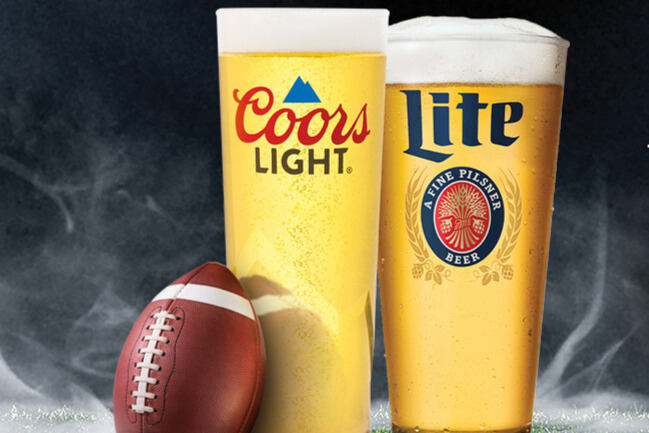 Two cold glasses of Coors Light and Miller Lite beer next to a football, representing the Molson Coors Football Experience Sweepstakes prize promotion, football-themed beer giveaway, and prepaid card sweepstakes.