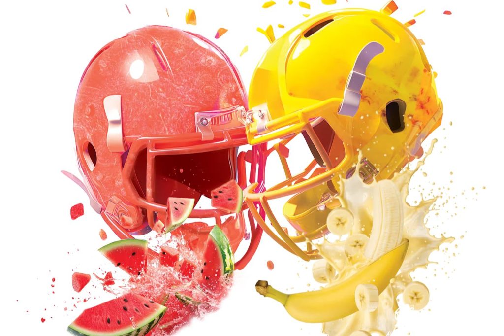 Two football helmets colliding, one red with watermelon splash and one yellow with banana splash, representing the 99 Brand Football Promotion instant win game and sweepstakes giveaway with swag bag prizes and a $999 check grand prize.