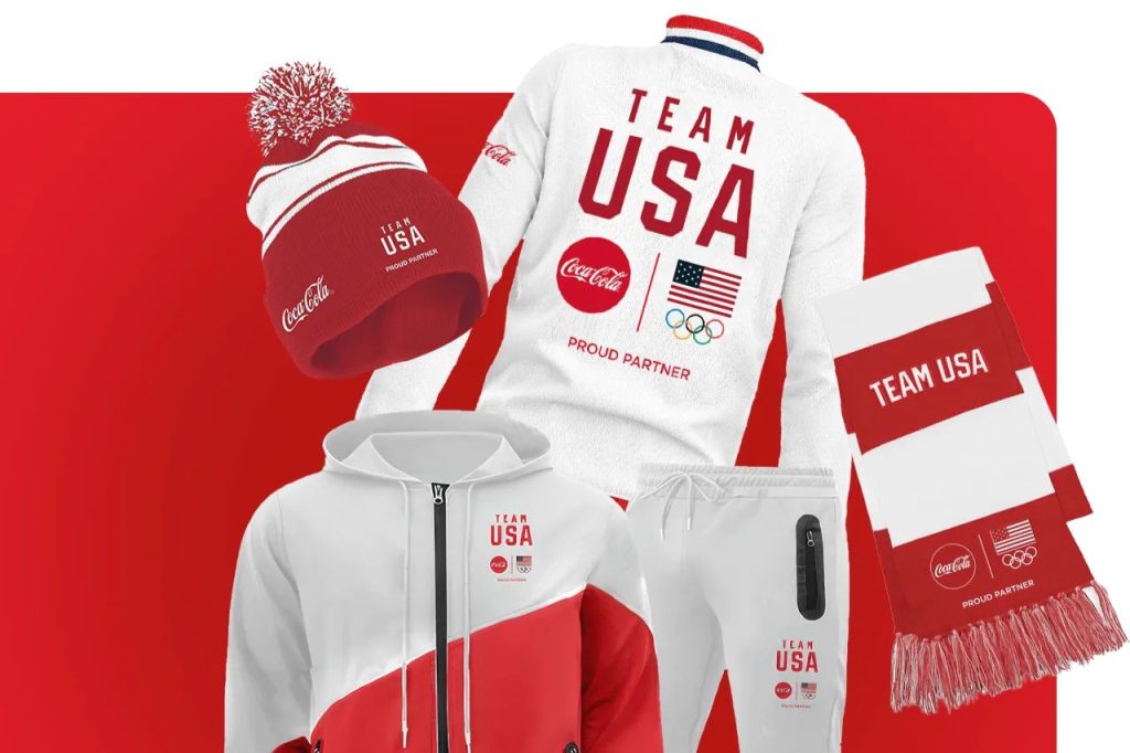 Coca-Cola Team USA sweepstakes prize bundle showing a red Team USA beanie, red-and-white Team USA scarf, and white Team USA jacket and sweats set with Olympic branding. Coca-Cola Swag with Every Sip instant win prizes featuring Team USA apparel and accessories, including jackets, scarf, beanie, and matching sweats. Team USA merch prize pack image for a Coca-Cola instant win game promoting Milano Cortina 2026 themed swag and Team USA gear.