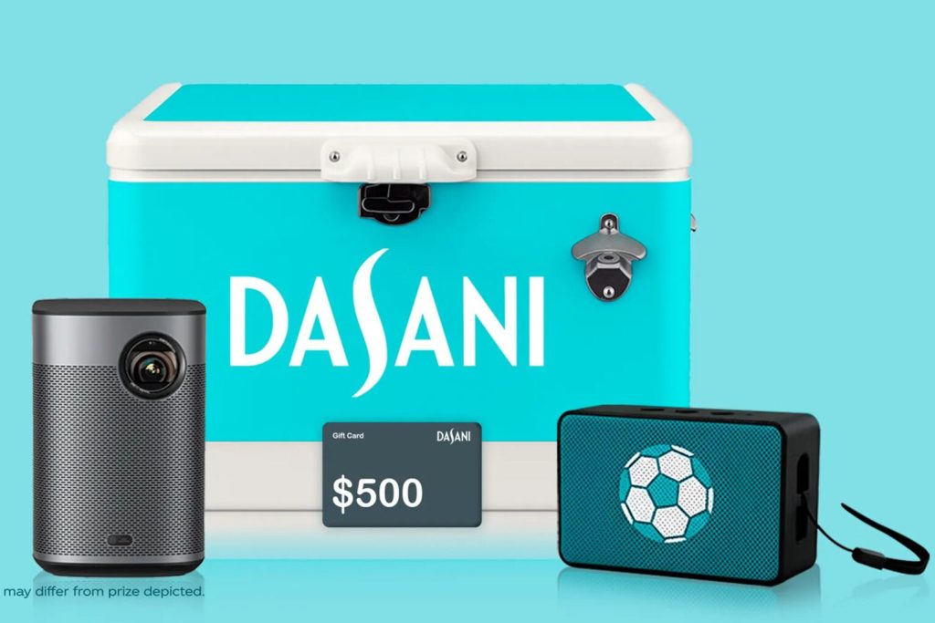 A Dasani branded cooler displayed with a projector, portable speaker, and a $500 prepaid card representing the FIFA World Cup 26 watch party grand prize package. The image showcases a complete home soccer viewing setup including entertainment gear and cash value components as part of the Dasani Watch Party Sweepstakes. This prize bundle highlights big-screen viewing equipment, hosting essentials, and prepaid card value included in the FIFA watch party giveaway.