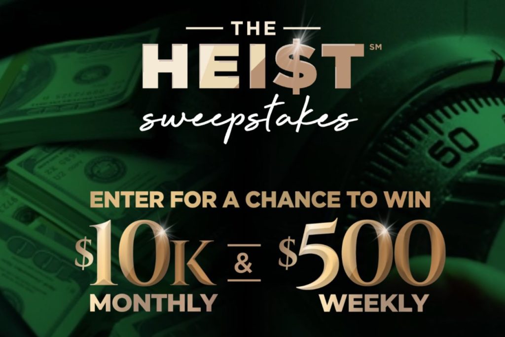 Promotional image showing stacks of cash and a vault dial representing The Heist Sweepstakes cash prizes, highlighting $10,000 monthly prizes and $500 weekly giveaways, a cash sweepstakes with frequent chances to win.