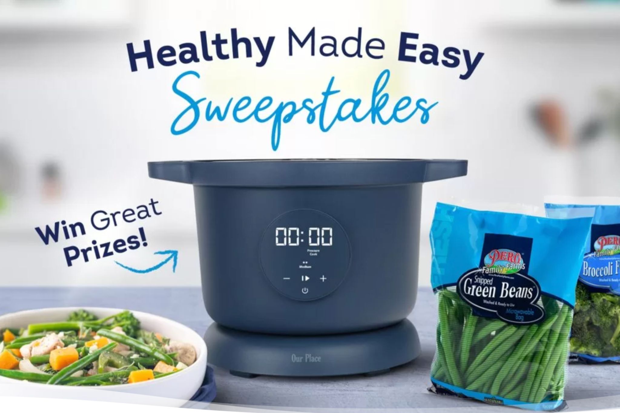 Healthy Made Easy Sweepstakes promotional image showing an Our Place Dream Cooker on a kitchen counter with Pero Family Farms frozen vegetables like snipped green beans and broccoli florets beside it, plus a bowl of veggies and chicken, highlighting a kitchen appliance giveaway and healthy cooking prize from Pero Family Farms.