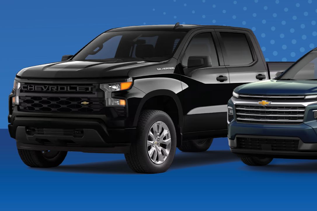 A black Chevrolet Silverado pickup and a blue Chevrolet SUV on a blue background, representing the grand prize vehicle in the Win a Chevy Sweepstakes. The image shows two Chevy vehicles side by side to highlight the giveaway prize of a winner’s choice Chevrolet model up to $50,000 MSRP. A featured Chevrolet truck and SUV illustrate the sweepstakes prize vehicle selection, emphasizing the chance to win a new Chevy through the Win a Chevy contest.