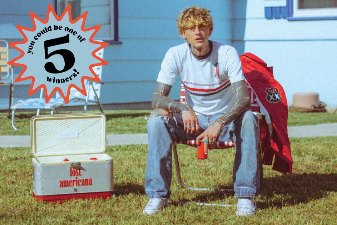 Owen’s Mixers MGK concert sweepstakes image showing Machine Gun Kelly sitting outdoors beside a cooler and gear with text saying you could be one of 5 winners. Promotional photo for the Owen’s Mixers Machine Gun Kelly concert giveaway featuring a casual backyard scene, highlighting five winners for a Rock Flight trip prize. MGK-themed sweepstakes creative for an Owen’s Mixers contest to win a concert trip experience with multiple winners and a travel-and-tickets prize package.