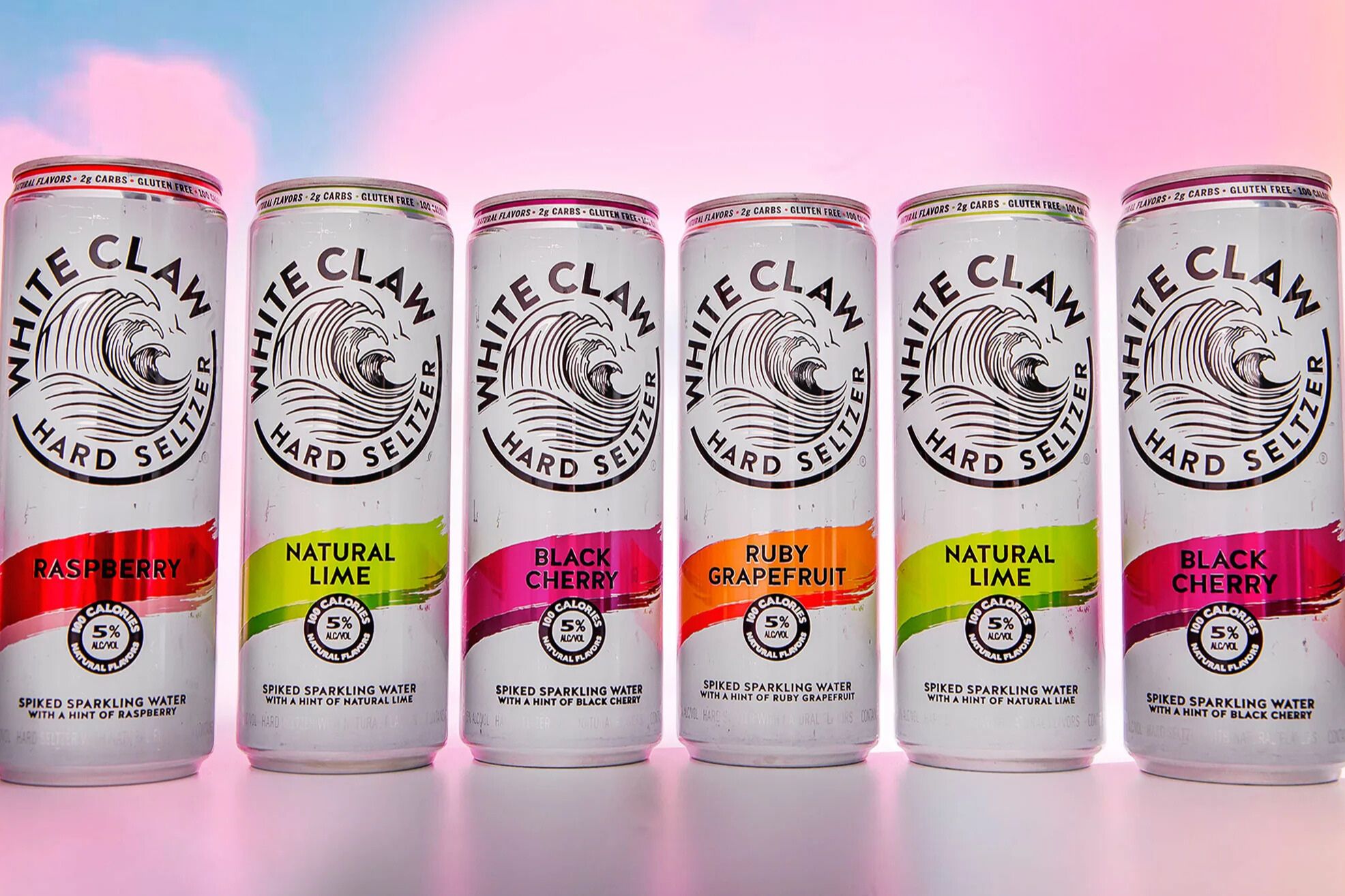 Six White Claw Hard Seltzer cans lined up in different flavors, representing the White Claw Home Theatre Sweepstakes prize promotion. White Claw hard seltzer cans shown in raspberry, lime, black cherry, and grapefruit flavors used to promote a $1,500 home theatre sweepstakes giveaway.