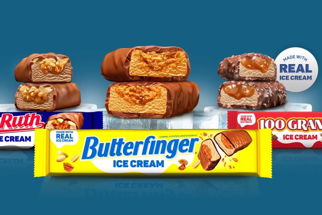Butterfinger, Baby Ruth, and 100 Grand ice cream bars displayed in a promotional image for the Double Treat Yourself Sweepstakes featuring candy-inspired ice cream treats and instant win prizes. Promotional image showing Butterfinger ice cream bars with chocolate coating and crunchy peanut butter center alongside Baby Ruth and 100 Grand ice cream bars for the Double Treat Yourself Sweepstakes giveaway. Ice cream candy bar treats including Butterfinger, Baby Ruth, and 100 Grand bars featured in a bright promotional graphic advertising the Double Treat Yourself experiential prize sweepstakes.