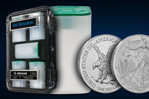 A Pelican storage case filled with silver bullion tubes alongside two American Silver Eagle coins, representing the JM Bullion Mini Monster Box Giveaway featuring 100 ounces of silver. The image shows physical silver bullion coins and tubes stored securely in a protective case. This silver sweepstakes prize highlights 100 ounces of investment-grade silver from JM Bullion.