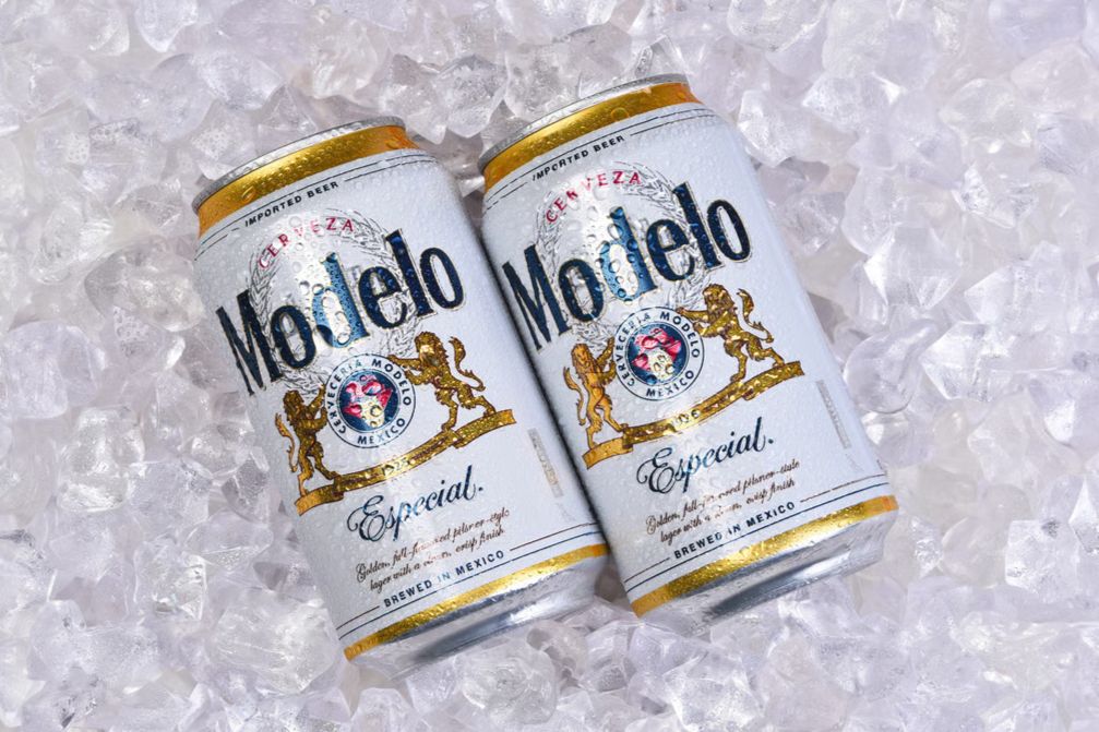 Two chilled Modelo Especial beer cans resting in crushed ice promoting the Modelo College Basketball Sweepstakes featuring branded college basketball gear prizes. Image showing Modelo beer cans on ice used to advertise the Modelo College Basketball sweepstakes giveaway with apparel prize packs. Promotional image of Modelo Especial cans surrounded by ice highlighting the Modelo basketball sweepstakes where entrants can win branded college basketball merchandise.
