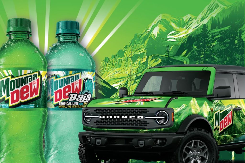 Two Mountain Dew bottles stand prominently next to a green Bronco SUV, all set against a vibrant green mountain backdrop. The scene exudes an adventurous, refreshing energy, featured in the 7-Eleven Ford Bronco Sweepstakes