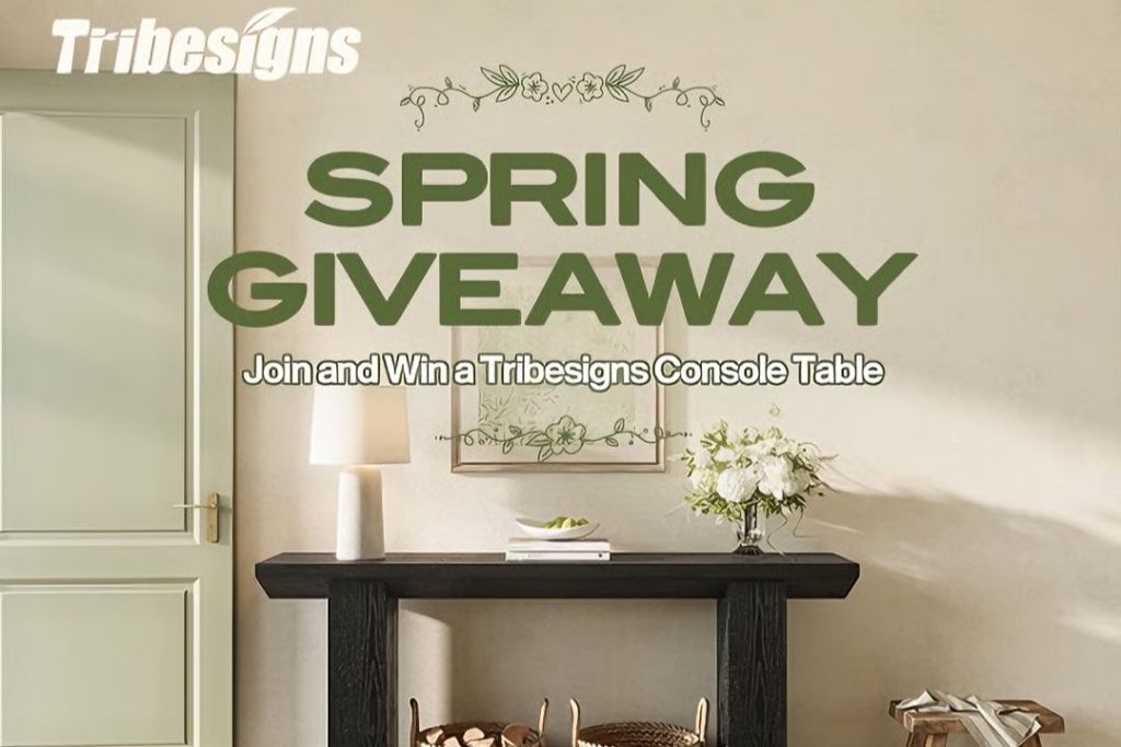 A stylish interior features a black console table adorned with a vase of white flowers, set against a softly painted wall and a decorative frame above, featured in the Tribesigns Console Table Sweepstakes