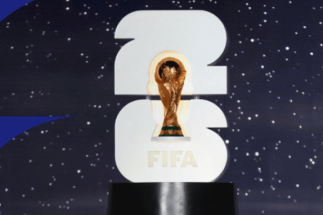 A golden trophy sits on a black pedestal, flanked by large white numbers '2026' and 'FIFA', against a starry background, symbolizing the upcoming tournament, featured in the Visa FIFA World Cup Sweepstakes