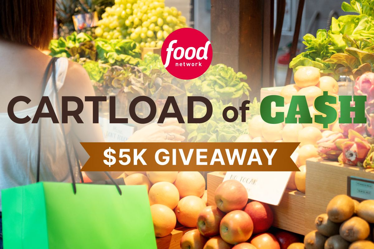 A person picks out fresh produce at a market stand, surrounded by vibrant fruits and vegetables, with a green shopping bag visible, featured in the Food Network $5,000 Sweepstakes