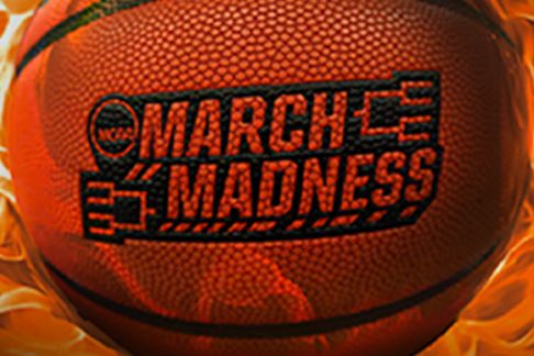 A basketball surrounded by a fiery background, prominently featuring the "March Madness" logo, capturing the excitement and energy of the tournament, featured in the Home Depot March Madness Sweepstakes
