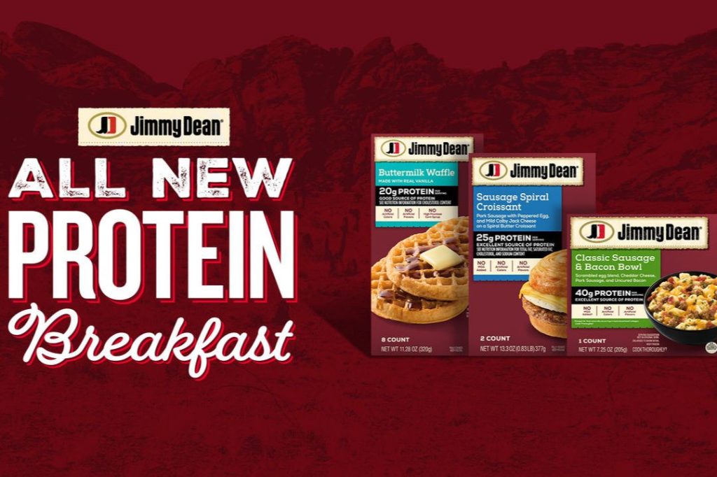 Three breakfast meal boxes are displayed prominently, showcasing a buttermilk waffle, sausage spiral croissant, and a classic sausage and bacon bowl on a textured red background, featured in the Jimmy Dean Stagecoach Sweepstakes