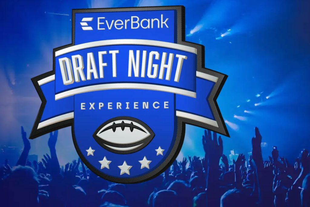 A vibrant crowd with raised hands celebrates at a lively event, illuminated by blue lights, showcasing an emblem for a Draft Night experience, featured in the EverBank Draft Night Sweepstakes