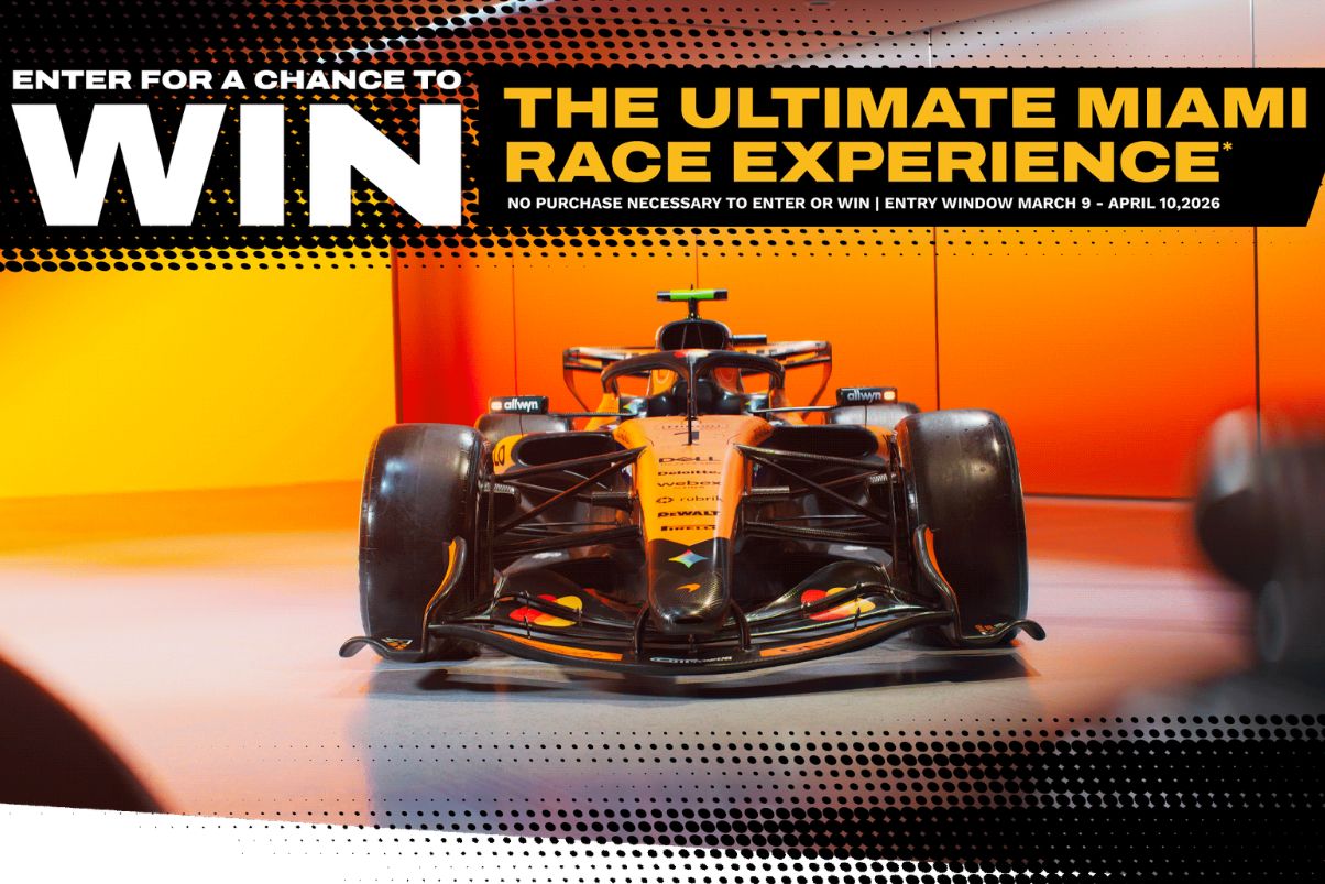 A sleek Formula 1 car with a striking orange and black design is displayed against a gradient background, highlighting its aerodynamic features and competition-ready stance, featured in the DEWALT Miami Race Experience Sweepstakes