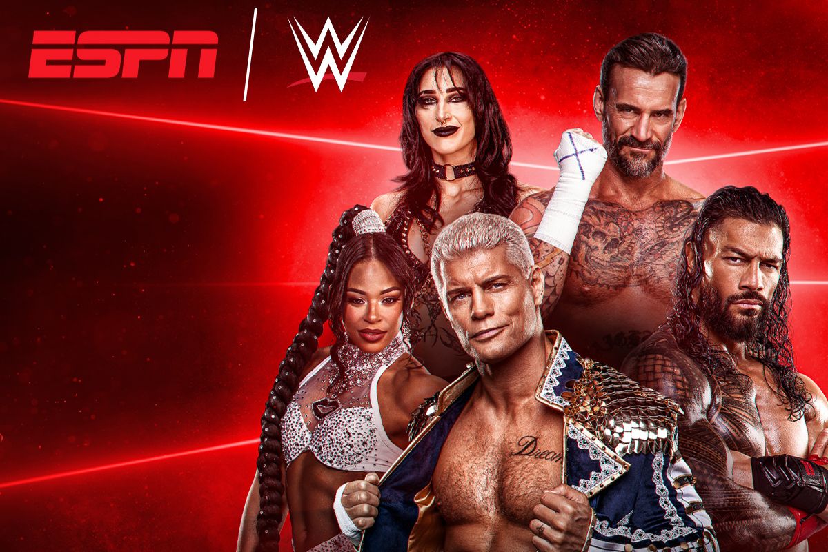 A group of four wrestling performers poses confidently against a vibrant red background, showcasing their unique styles and personalities, highlighting the excitement of professional wrestling, featured in the Disney+ WrestleMania 42 Sweepstakes