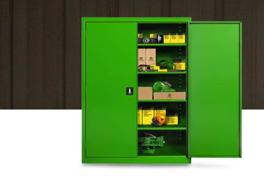 A bright green storage cabinet stands against a dark wooden background, showcasing neatly organized shelves filled with various tools and safety equipment, featured in the John Deere Parts Cabinet Sweepstakes