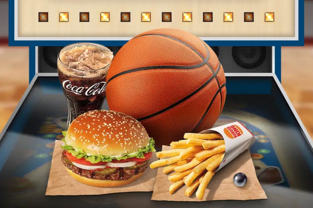 A basketball, burger, fries, and a soda sit on a tabletop, creating a casual food scene, likely themed around a sports event or gathering, featured in the Burger King Full-Court Flip Sweepstakes