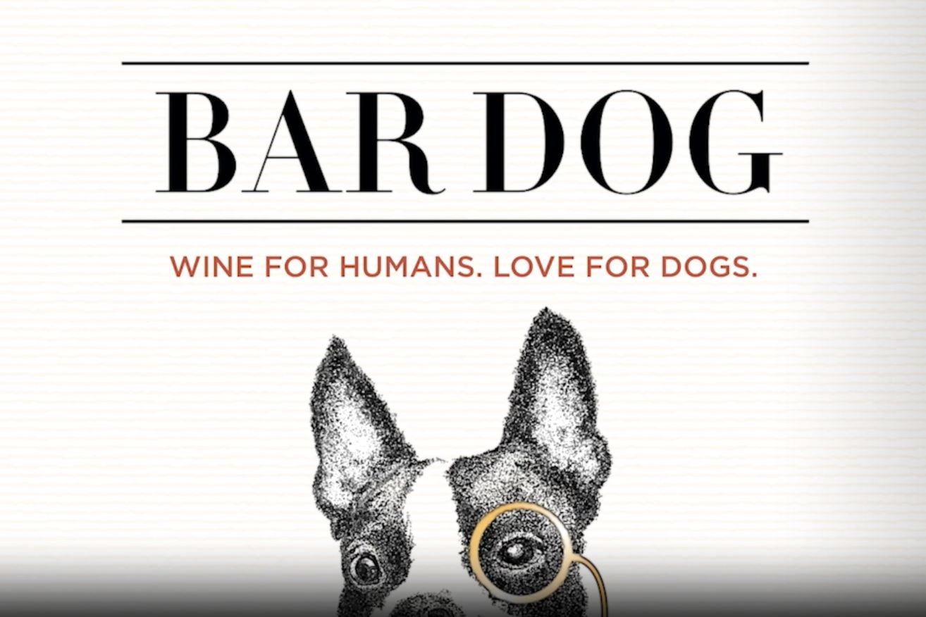 A whimsical illustration of a dog wearing round glasses, accompanied by the text "Wine for Humans. Love for Dogs," highlighting a playful connection between pets and wine, featured in the Bar Dog Label Sweepstakes