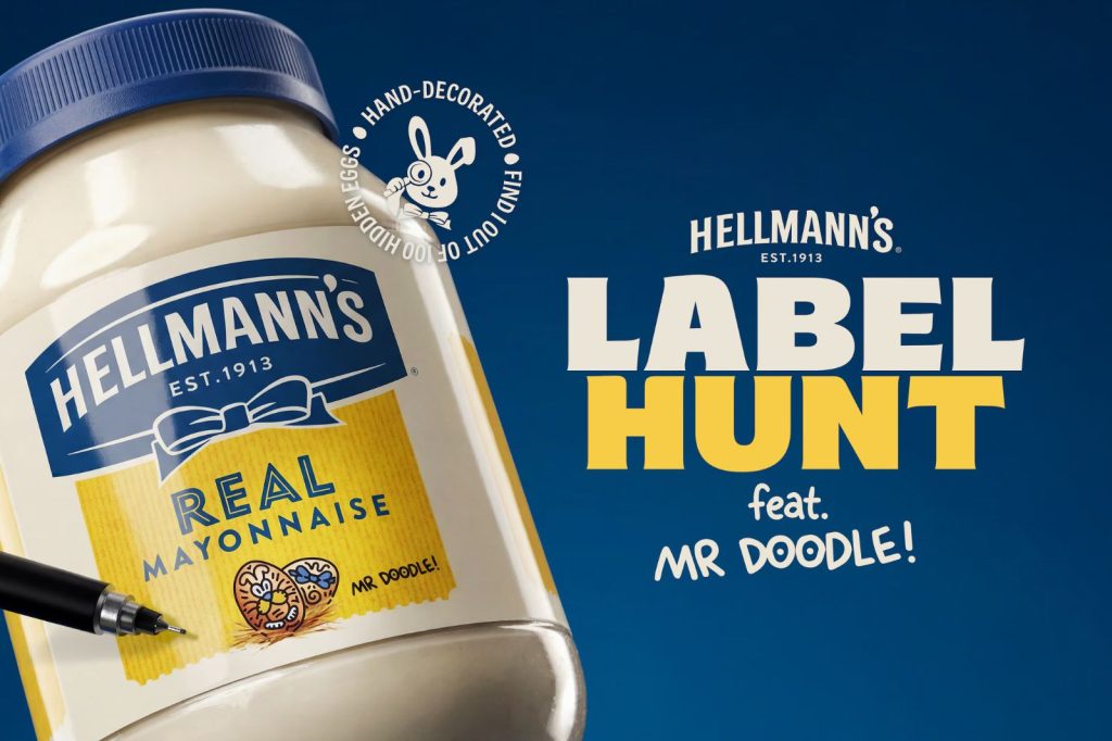 A close-up of a jar of mayonnaise featuring a colorful doodle by Mr. Doodle on the label, set against a bright blue background with playful text promoting a label hunt, featured in the Hellmanns Label Hunt Sweepstakes