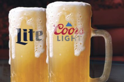 Two frosty mugs of beer with thick foam atop, one labeled "Lite" and the other "Coors Light," set against a warm, blurred background, featured in the Coors Light Miller Lite $500 Sweepstakes