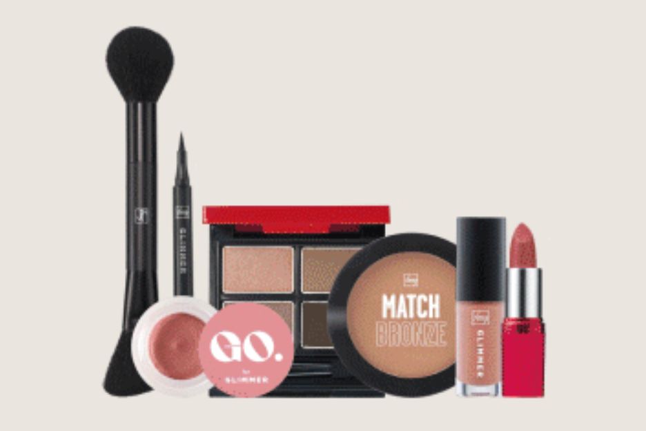 A collection of makeup products arranged neatly, including brushes, blush, eyeshadow palette, lipstick, and a bronzer, showcasing a variety of cosmetics for creating a complete look, featured in the Spring Beauty Refresh Sweepstakes
