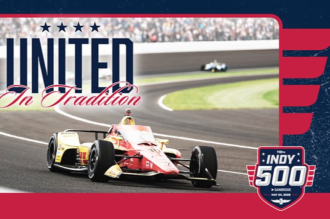 A bright yellow and red race car speeds around a curve on a racetrack, with spectators cheering in the background, emphasizing the excitement of the iconic Indy 500 event, featured in the Prairie Farms Indy 500 Sweepstakes