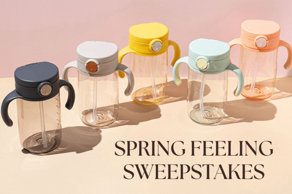 A colorful array of five transparent water bottles with distinctive caps and handles is displayed against a soft pink background, showcasing a fresh spring vibe, featured in the Richell Spring Feeling Sweepstakes 2026