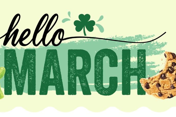 A decorative design features the phrase "hello March" in bold green letters, accented by a shamrock and a chocolate chip cookie, celebrating the arrival of spring, featured in the Snackworks Gift Basket Sweepstakes