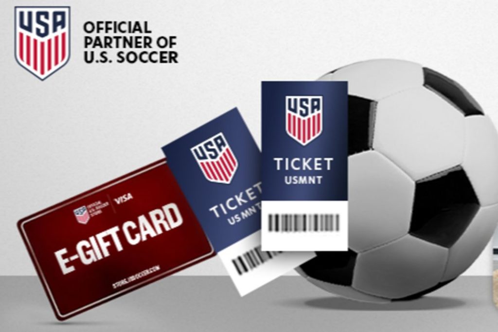 A soccer ball rests beside an e-gift card and two tickets for a U.S. men's national team match, highlighting the excitement of attending a soccer event, featured in the Haleon USSF Soccer Sweepstakes