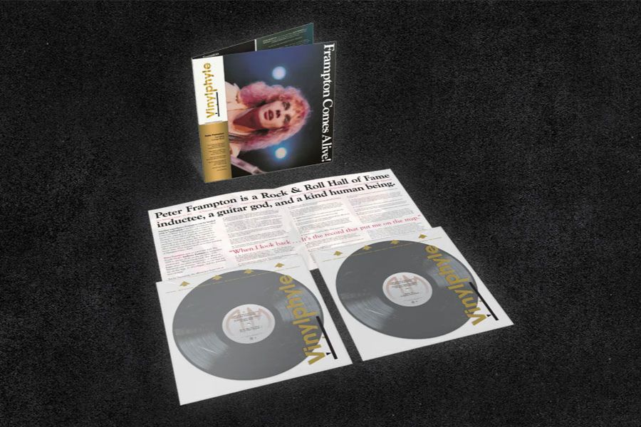 A vinyl album titled "Frampton Comes Alive!" is displayed alongside two black records and an article highlighting Peter Frampton's impact as a Rock & Roll Hall of Fame inductee, featured in the uDiscover Music Peter Frampton Giveaway