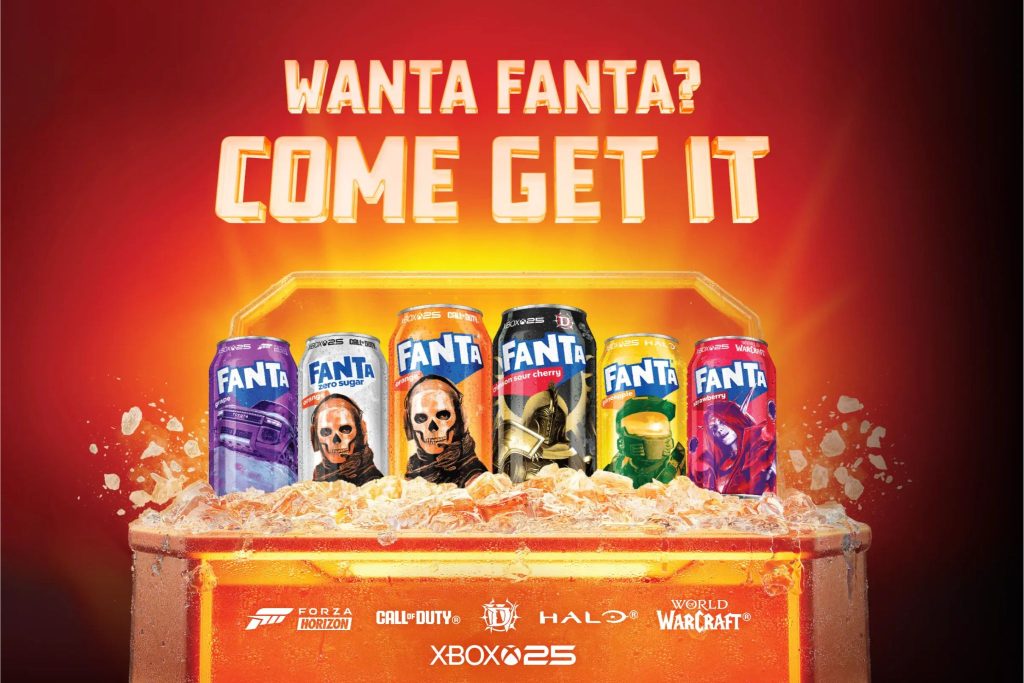 A vibrant display features various Fanta soda cans arranged in a container filled with ice, set against a fiery red background, inviting viewers to indulge, featured in the Coca-Cola BlizzCon Sweepstakes