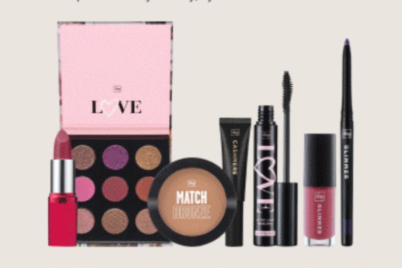 A colorful array of makeup products displayed, including a lipstick, eyeshadow palette, mascara, eyeliner, and blush compact, showcasing a vibrant selection for beauty enthusiasts, featured in the Avon Mom's Moment to Glow Sweepstakes