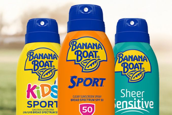 Three colorful sunscreen spray bottles arranged closely, showcasing a yellow kids’ formula, a vibrant orange sport version, and a teal sheer sensitive option, featured in the Swing Into the Sun Sweepstakes