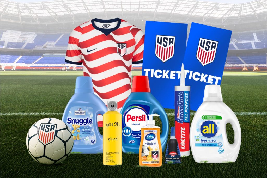 A soccer jersey with red and white stripes is prominently displayed alongside cleaning products, a soccer ball, and tickets, all set against a stadium backdrop, featured in the Summer of Soccer Sweepstakes