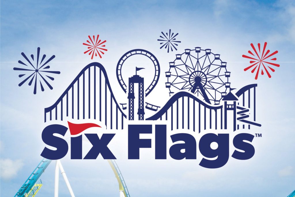A vibrant amusement park scene displays roller coasters, a Ferris wheel, and fireworks against a bright sky, capturing the excitement of a thrilling day at the park, featured in the Coca-Cola Six Flags Sweepstakes