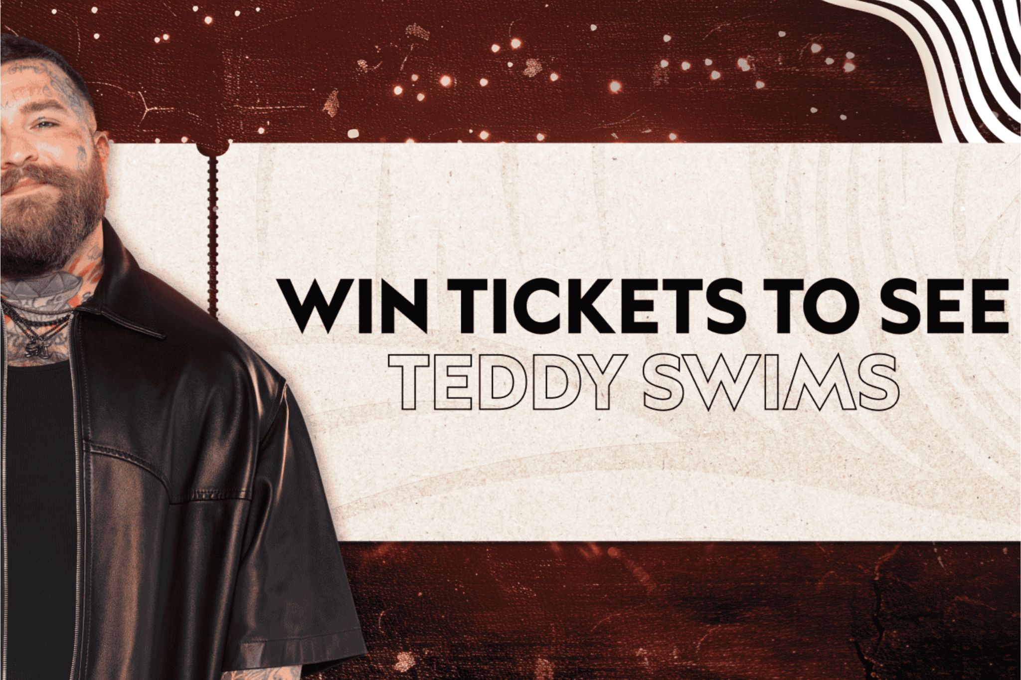 A man with tattoos smiles, wearing a black shirt and chain necklace against a textured background, promoting a chance to win tickets for an event featuring Teddy Swims, featured in the White Claw Teddy Swims Sweepstakes