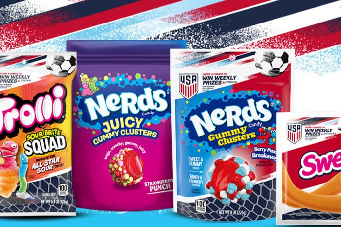 A colorful display of various candy packages, including Trolli Sour Brite Squad, Nerds Juicy and Gummy Clusters, and Sweet Tarts, set against a vibrant, patriotic background, featured in the Sweeten the Fandom Sweepstakes