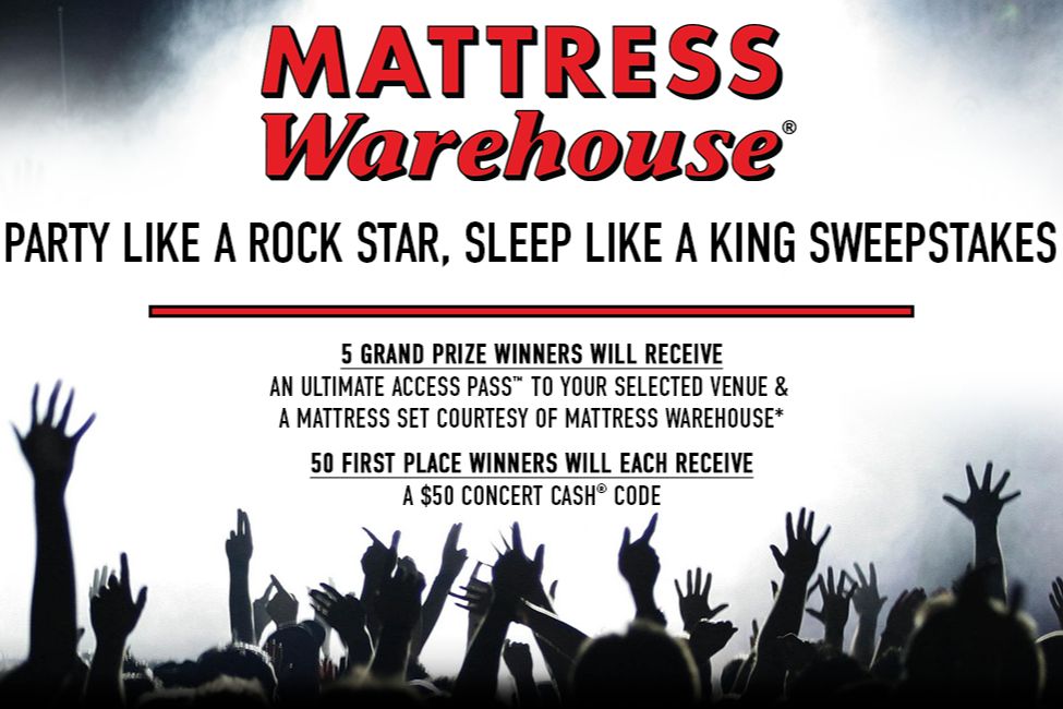 A lively crowd with raised hands enjoys a concert atmosphere, surrounded by lights and excitement, celebrating a promotional event for a sweepstakes, featured in the Mattress Warehouse Concert Pass Sweepstakes