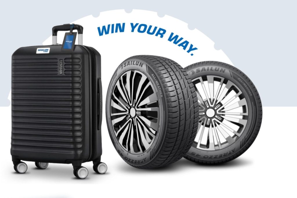 A sleek black suitcase stands beside two branded all-weather tires, creating a travel-themed scene. The background features a light blue design with stylized text, featured in the Sailun Tire Spring Sweepstakes