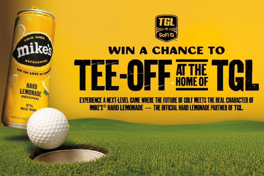 A close-up of a golf ball poised near a hole on a green, alongside a can of hard lemonade against a vibrant yellow backdrop promoting a golfing experience, featured in the Mikes Hard Lemonade Golf Experience Sweepstakes