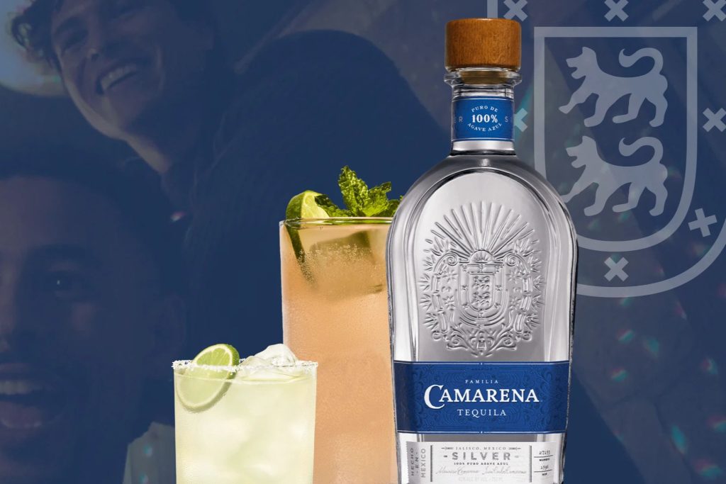 A clear bottle of tequila sits between two colorful cocktails garnished with lime and mint, with smiling faces blurred in the background, creating a lively, festive atmosphere, featured in the Camarena TV & Cash Sweepstakes
