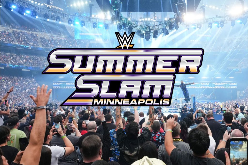 A lively crowd cheers as a performer soars above the ring during a wrestling event, illuminated by vibrant lights in a packed arena. Excited fans capture the moment on their phones, featured in the Minute Maid SummerSlam Sweepstakes