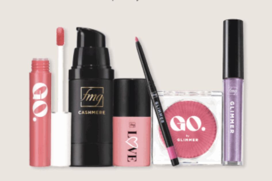 A collection of makeup products displayed in a row, including a lip gloss, foundation, blush, lip liner, and shimmering lip gloss, all showcasing various vibrant colors, featured in the Avon Summer Beauty Sweepstakes