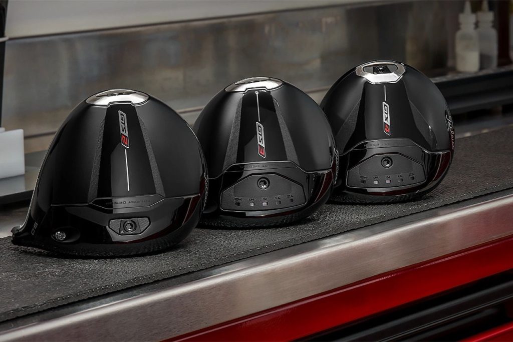 Three sleek black golf clubs are positioned neatly on a dark work surface, showcasing their modern design and features, ready for use on the course, featured in the Titleist GTS Driver Sweepstakes