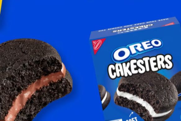 A close-up of two Oreo Cakesters, one with a chocolate filling and the other with cream filling, displayed alongside the blue packaging on a vivid background, featured in the OREO Cakesters Sweepstakes