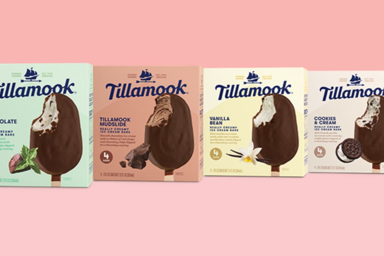 Four ice cream bar boxes are displayed against a pink background, featuring flavors: Chocolate, Tillamook Mudslide, Vanilla Bean, and Cookies & Cream, each with a partially bitten treat visible, featured in the Tillamook Ice Cream for a Year Sweepstakes